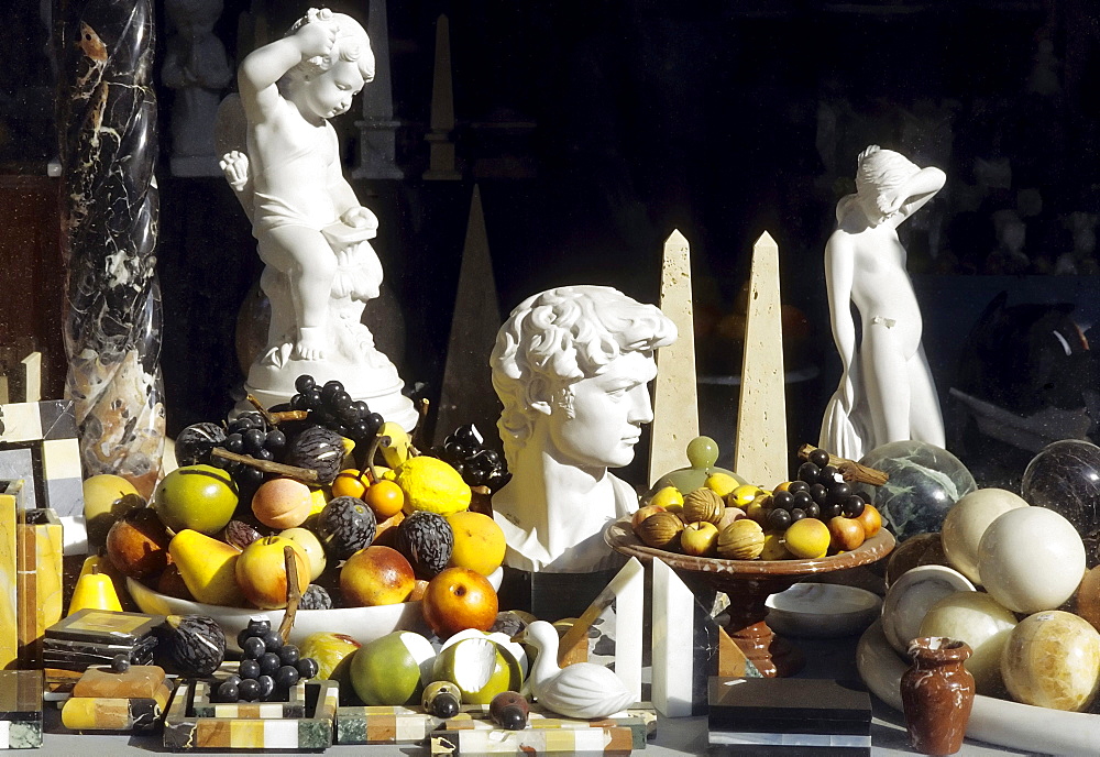 Small marble figures and colourful fruit of painted marble, decorations in a shop window, Carrarra, Tuscany, Italy, Europe