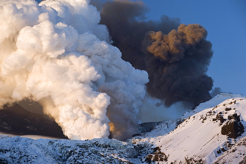 Cloud of ash from Eyjafjallajoekull volcano and a steam plume from the lava flow in Gigjoekull glacier tongue, Iceland, Europe