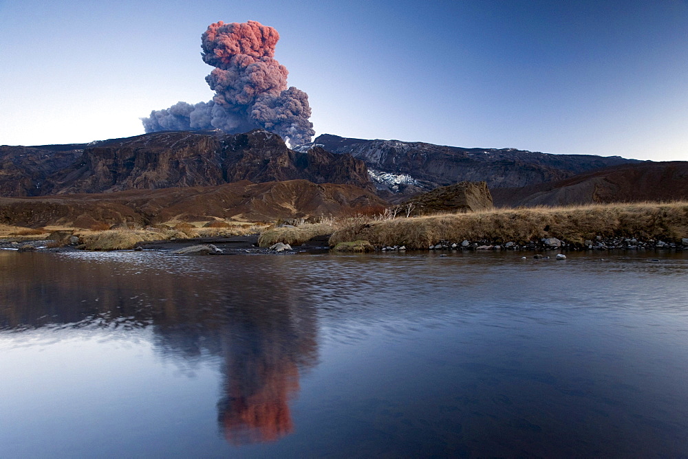 Eyjafjallajoekull volcano, the ash cloud mirroring in a small lake, ï¬orsmoerk, Thorsmoerk mountain ridge, Iceland, Europe