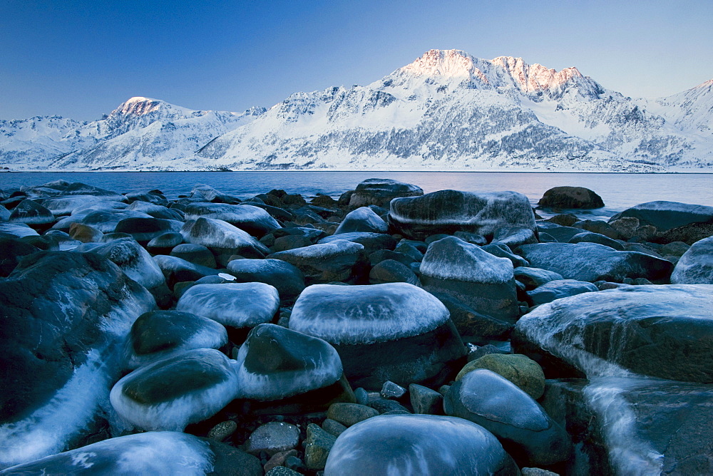 Ice-capped rocks on the coast of Nuvsfjorden Nuvsfjord, Finnmark, Norway, Europe