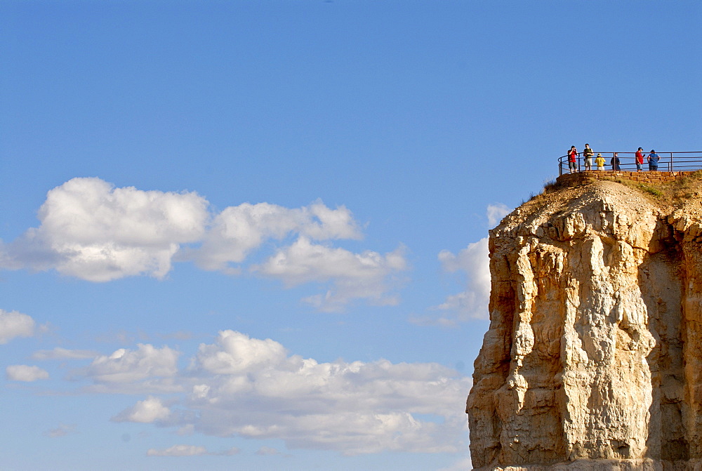 Tourists on a lookout on a hoodoo, spire of rock, in Bryce Canyon, Utah, USA