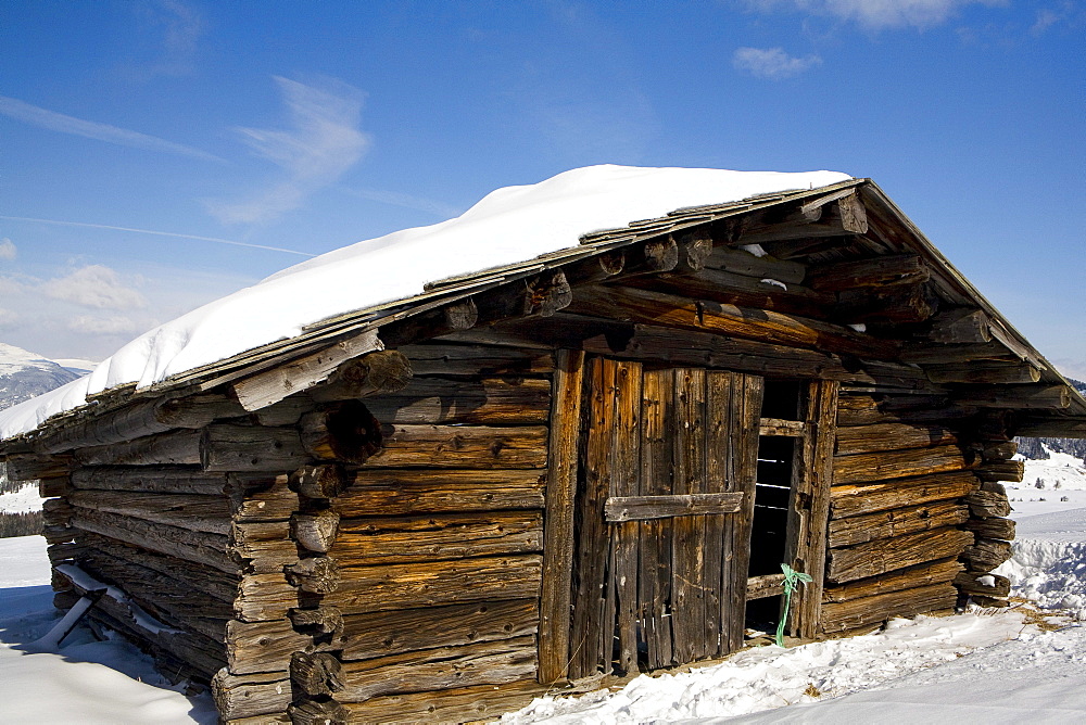 Wooden hut on the Seiser Alm alpine pasture, South Tyrol, Italy, Europe