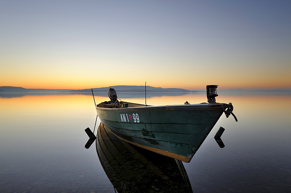 Evening mood with a fishing boat on the shore of the island of Reichenau, Konstanz district, Baden-Wuerttemberg, Germany, Europe