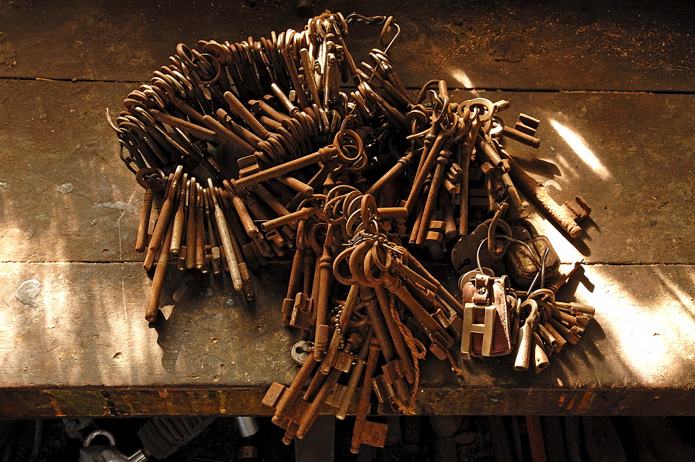 Rusty door keys lying on a workbench