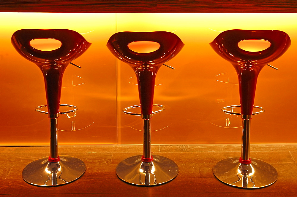 Three red plastic bar stools in front of a bar at a school of hotel management, Lycee Economique et Hotelier Joseph Storck, Rue du Chemin Noir street, Guebwiller, Gebweiler, Alsace, France, Europe