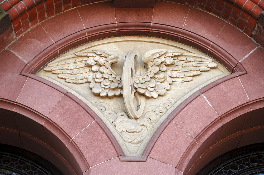 Relief with wings and a wagon wheel, a common theme in the logo of railway companies, former Reichsbahn railway building, Station 15, Schwerin, Mecklenburg-Western Pomerania, Germany, Europe