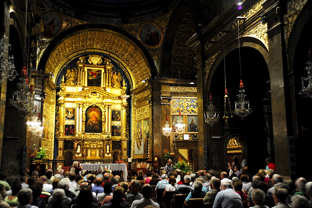 Place of pilgrimage, visitors in front of the church altar, monastery Santuari de Lluc in the Tramuntana mountains, Majorca, Balearic Islands, Mediterranean, Spain, Europe