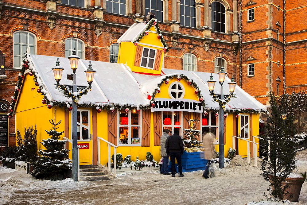 Yellow snow-covered house in Tivoli, Copenhagen, Denmark, Europe