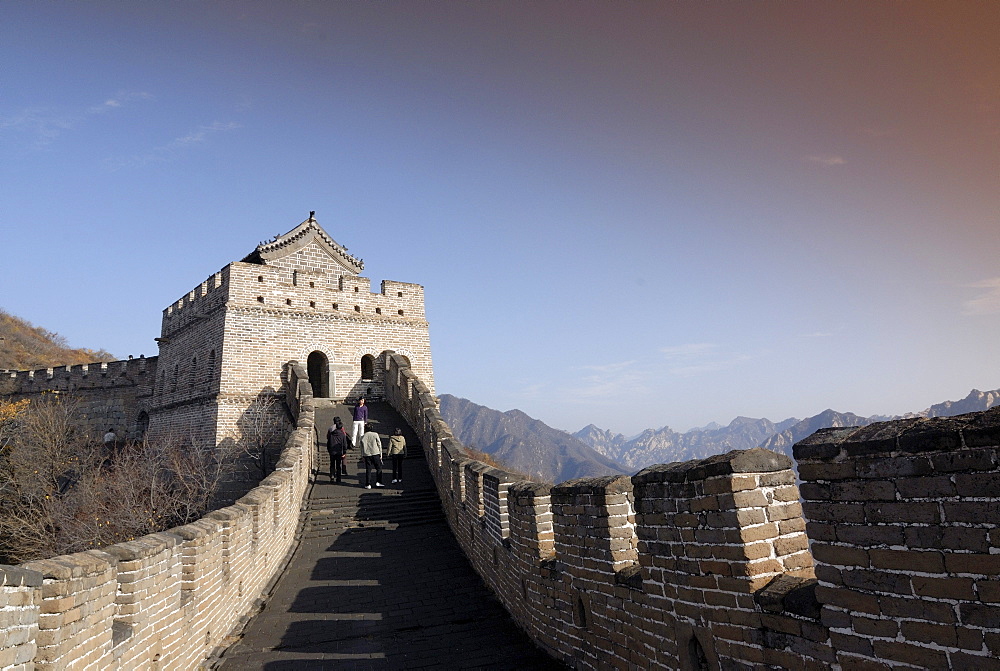 Tourists walking towards a guard tower on the Great Wall of China at Mutianyu in autumn, UNESCO World Heritage Site, near Beijing, China, Asia