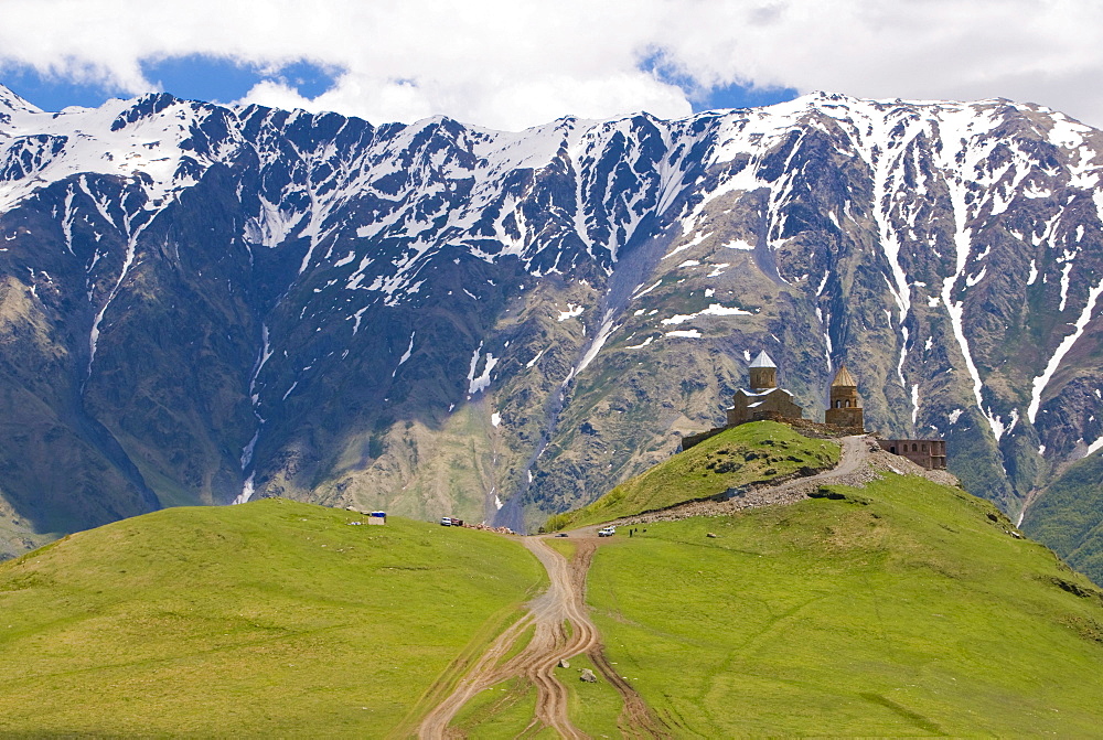 The famous Gergeti Trinity Church or Tsminda Sameba at the Chechen border, Stepantsminda, Georgia, Caucasus, Middle East