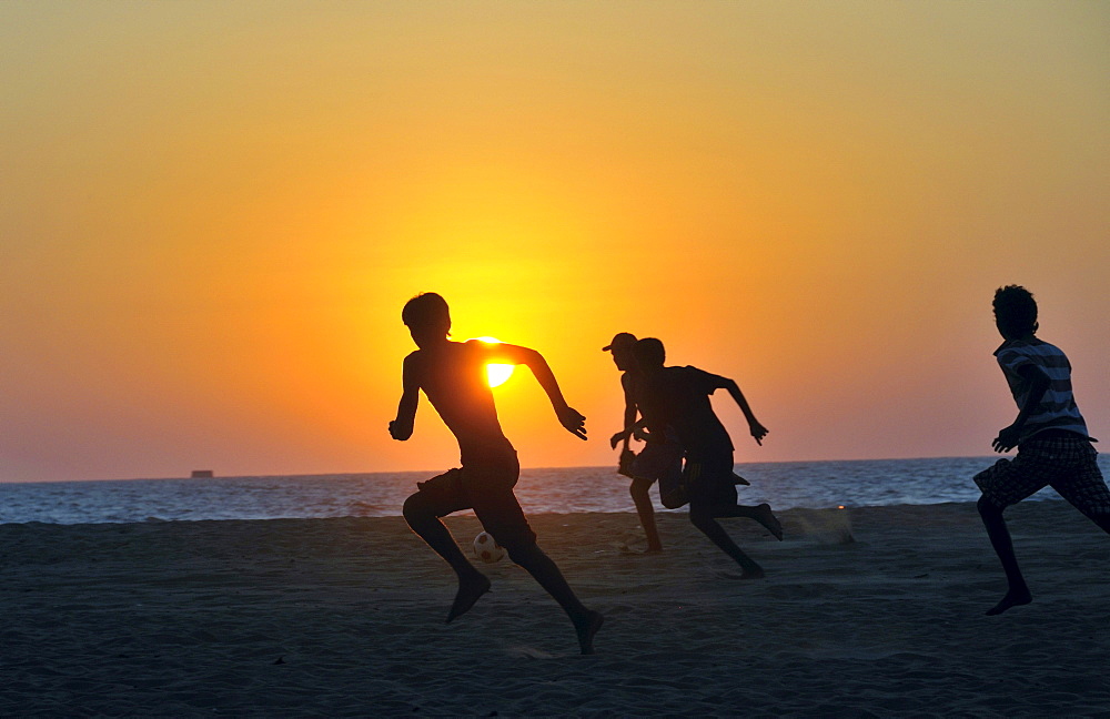 Young men playing football on the beach, Negombo, Sri Lanka, Ceylon, South Asia, Asia