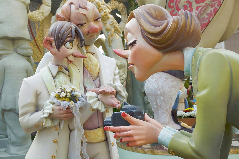 Crude carnival characters and satirical sculptures, woman filming a gay wedding, Fallas festival, Falles festival in Valencia in early spring, Spain, Europe