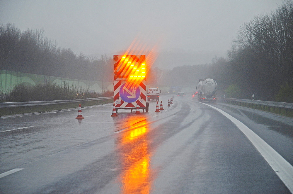 Bright traffic sign, road works, route diversion, sign, rain, fog, bad weather, poor visibility, traffic, A 45 motorway, Sauerland area, North Rhine-Westphalia, Germany, Europe