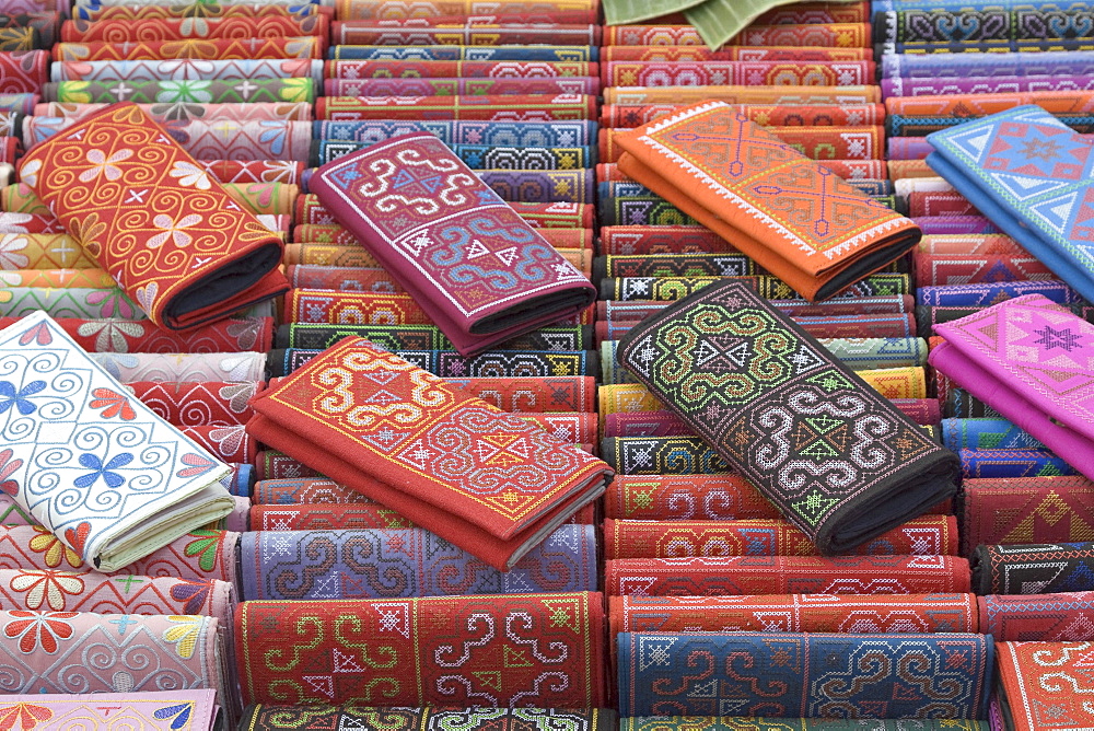 Colourful traditional wallets on display at a market stall in Luang Prabang, Laos, Southeast Asia