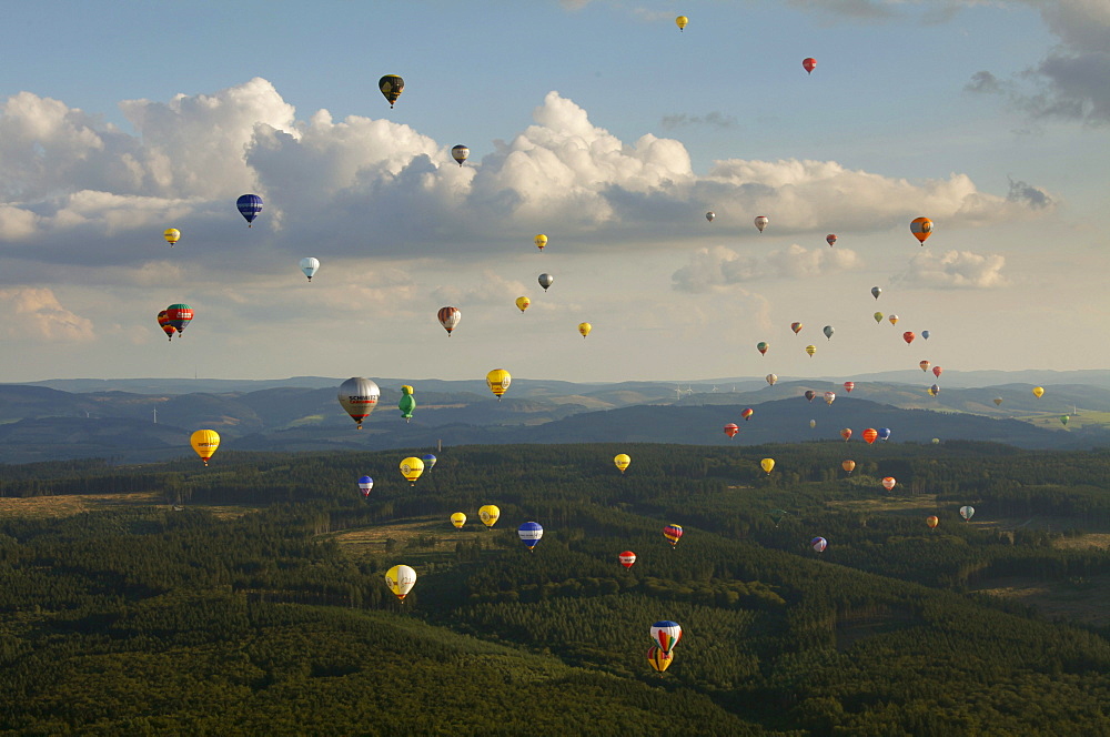 Aerial view, 20th Warsteiner Montgolfiade, hot-air-balloon festival with nearly 200 hot-air-balloons ascending into the sky, Warstein, Sauerland, North Rhine-Westphalia, Germany, Europe