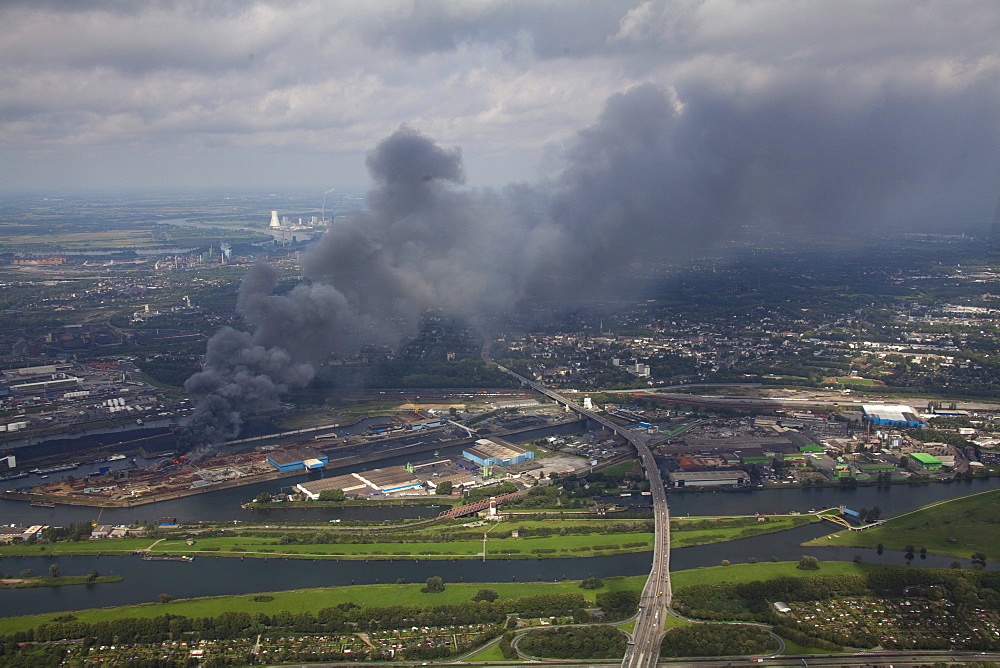 Aerial view, smoke, fire on a scrap island in the Duisport inland port, Duisburg, Ruhrgebiet region, North Rhine-Westphalia, Germany, Europe