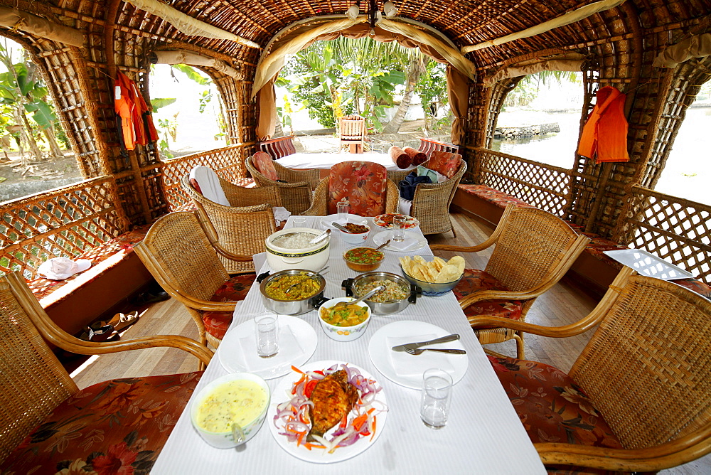 Dining table on a luxury houseboat on a canal, Haripad, Alappuzha, Alleppey, Kerala, India, Asia