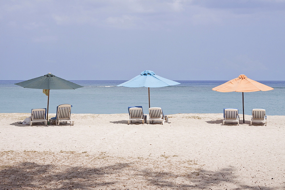 Sunloungers and beach umbrellas on the public beach of Flic en Flac, Mauritius, Africa