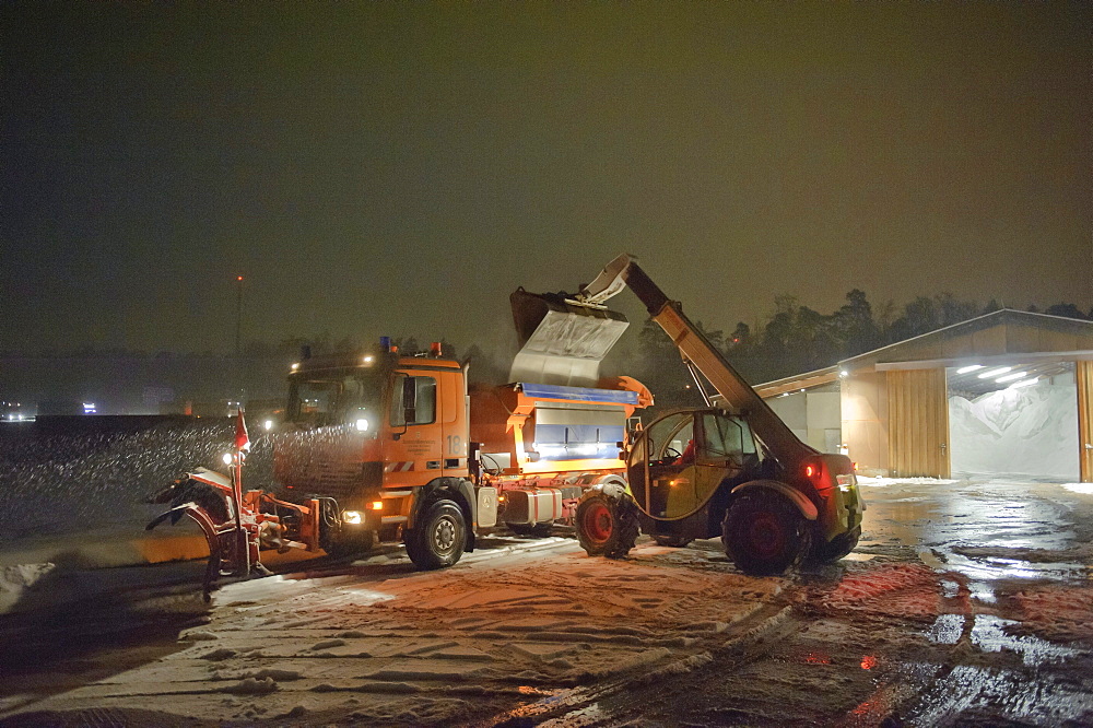 Winter services vehicles are loaded with road salt at the salt storage, motorway junction Stuttgart, Baden-Wuerttemberg, Germany, Europe