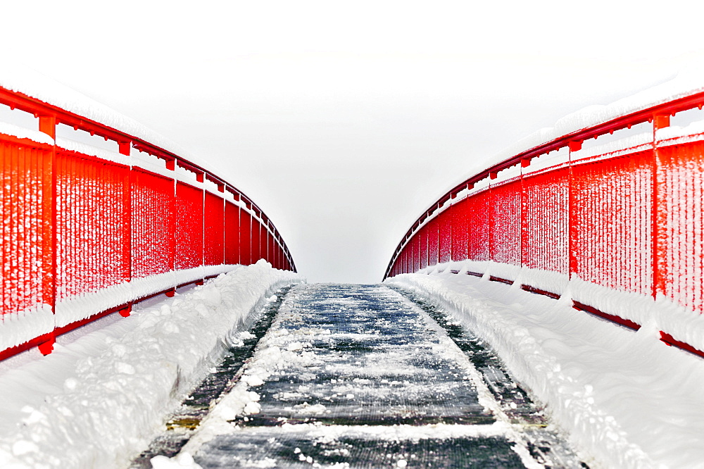 Red pedestrian bridge in the snow