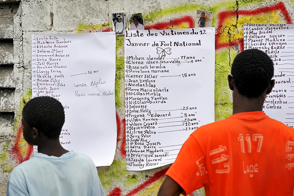 Residents viewing a list of victims of the earthquake in January 2010 on a house wall, Fort National district, Port-au-Prince, Haiti, Caribbean, Central America