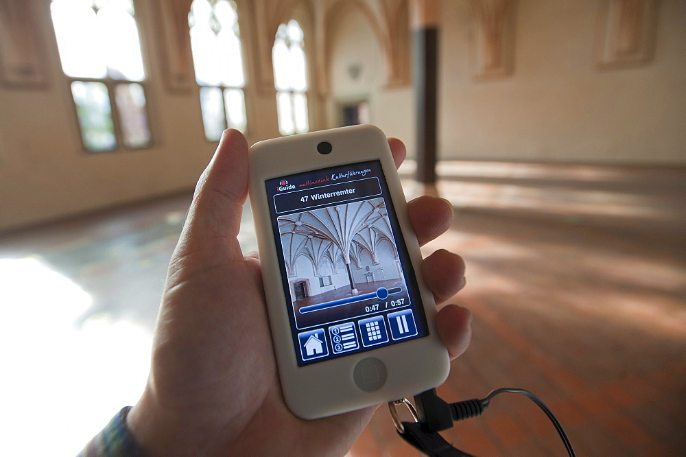 IPod held by a hand as an audio guide, Malbork Castle, Malbork, Pomerania, Poland, Europe