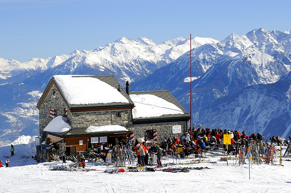 Skiers at the Les Violettes hut from the Swiss Alpine Club in the Valais Alps, Crans Montana, Valais, Switzerland, Europe