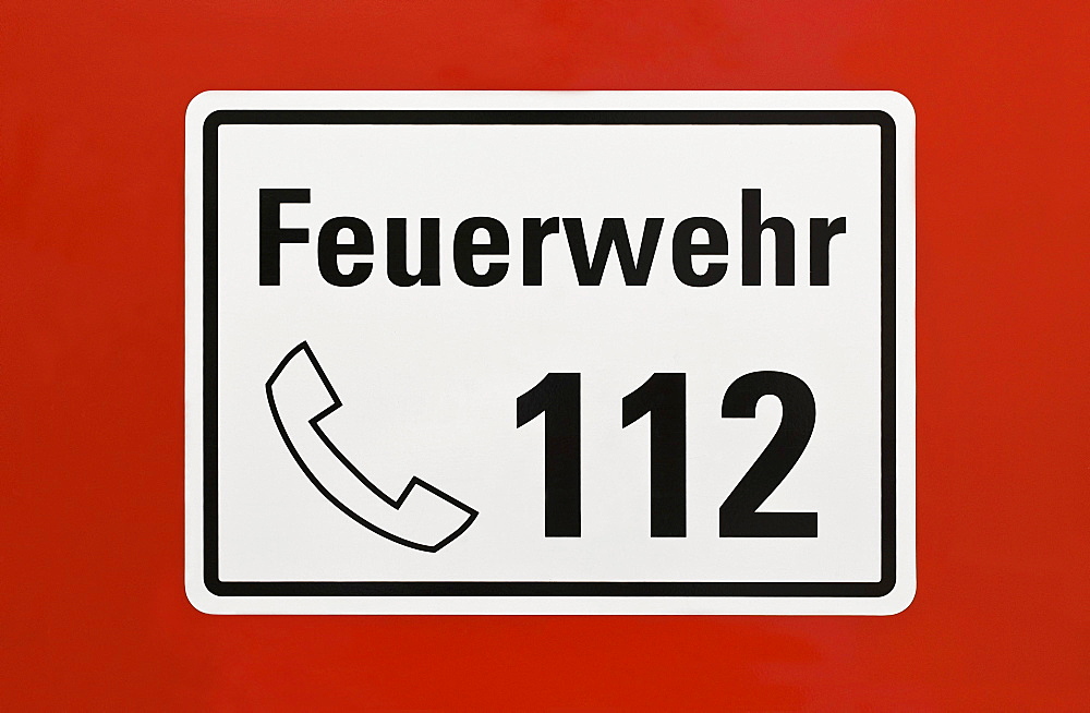 Sign, "Feuerwehr 112", German for "fire service 112", emergency telephone number, on a red surface