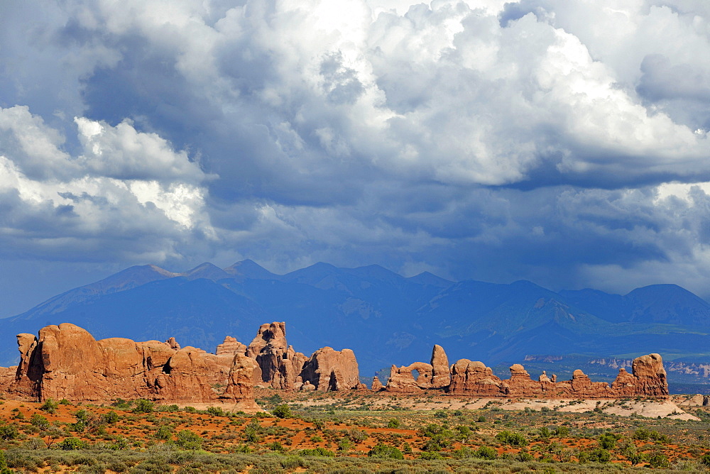 Rock formations of Turret Arch, rock arch, Elephant Butte, North Window, South Window, La Sal Mountains at the back, dramatic clouds, Arches National Park, Moab, Utah, Southwestern United States, United States of America, USA