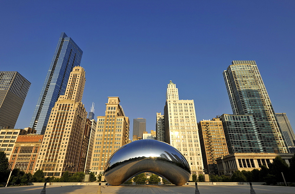 Cloud Gate sculpture, The Bean, by Anish Kapoor, in front of the skyline with the Legacy at Millennium Park Building, The Heritage, the Pittsfield Building, AT & T Plaza and Millennium Park, Chicago, Illinois, United States of America, USA