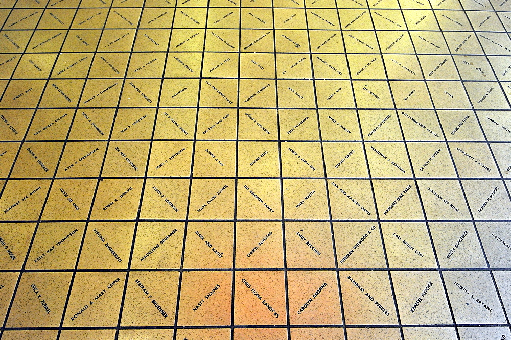 Sponsors names immortalized in bronze tiles from Rachel, the unofficial mascot, a lucky pig made of bronze, at the entrance of Pike Place Public Market, Seattle, Washington, USA