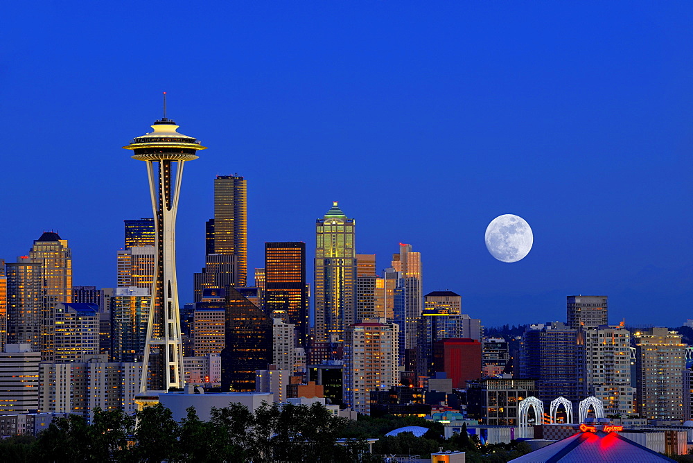 Night scene with full moon, skyline of the Financial District in Seattle, Space Needle, Columbia Center, formerly known as Bank of America Tower, Washington Mutual Tower, Two Union Square Tower, Municipal Tower, formerly Key Tower, US Bank Center, Washing