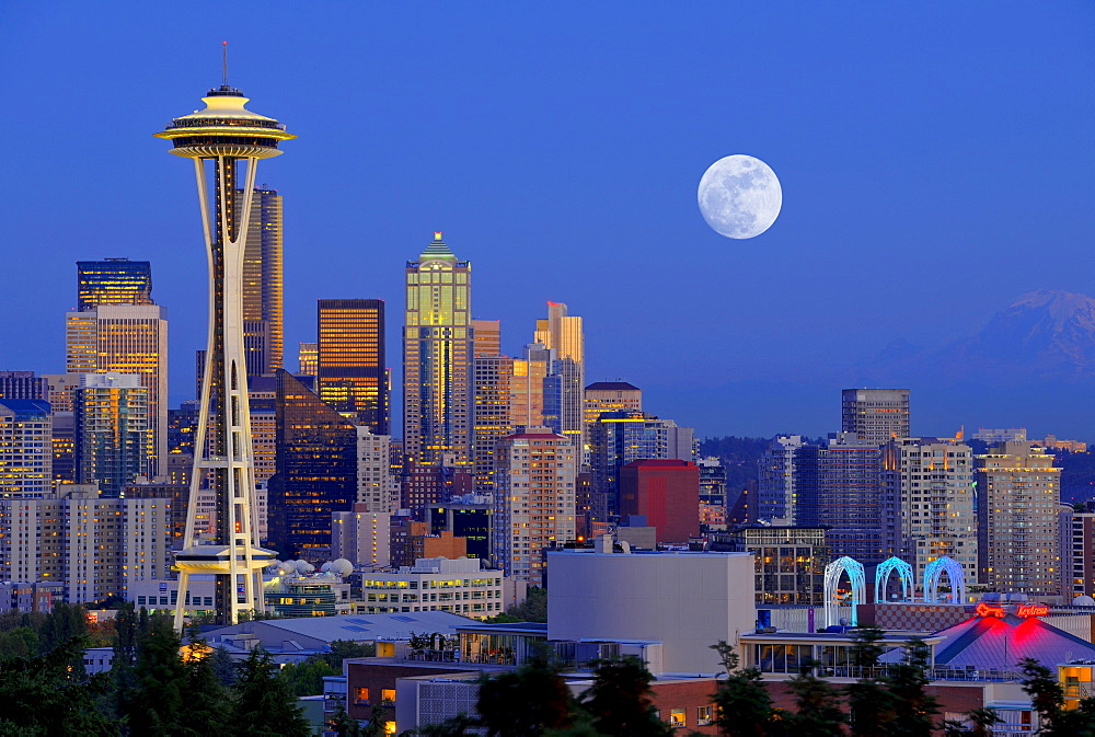 Night scene, skyline of the Financial District in Seattle with a full moon, Space Needle, Columbia Center, formerly known as Bank of America Tower, Washington Mutual Tower, Municipal Tower, formerly Key Tower, U.S. Bank Center, Washington, United States o