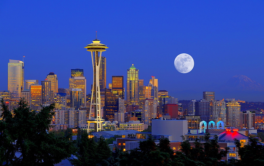 Night scene, skyline of the Financial District in Seattle with a full moon, Space Needle, Columbia Center, formerly known as Bank of America Tower, Washington Mutual Tower, Municipal Tower, formerly Key Tower, U.S. Bank Center, Washington, United States o