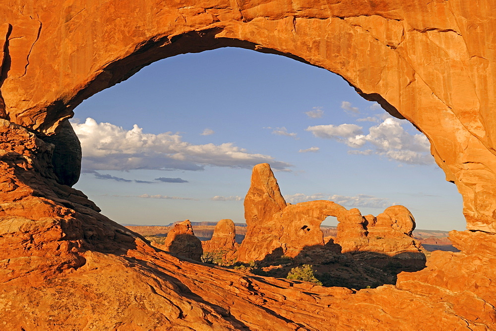 Looking through the North Window rock arch in the morning on the Turret Arch rock formation, Arches National Park, Utah, United States, America