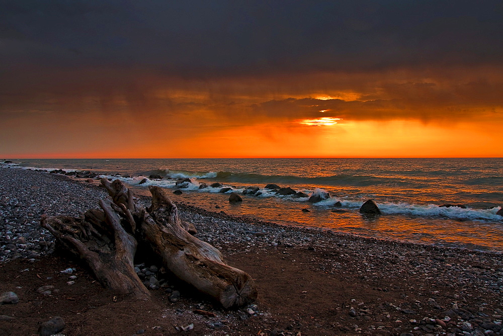 Beach at sunrise with rain clouds, Jasmund National Park, Ruegen, Mecklenburg-Western Pomerania, Germany, Europe