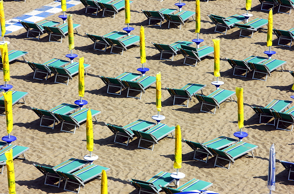 Parasols and empty sun loungers on the beach of Caorle, Adriatic Sea, Italy, Europe