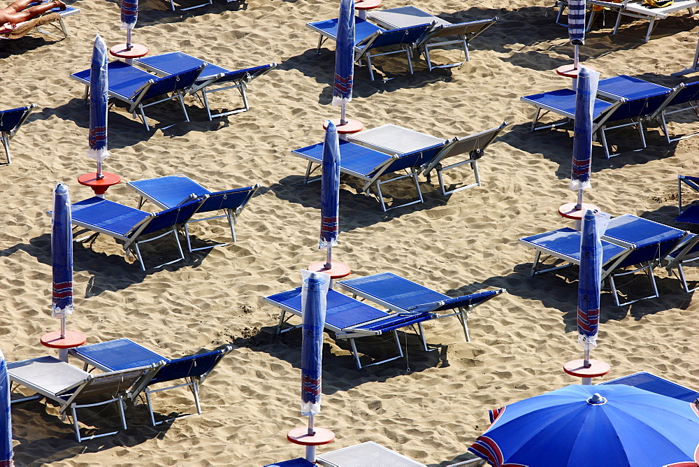 Parasols and empty sun loungers on the beach of Caorle, Adriatic Sea, Italy, Europerope