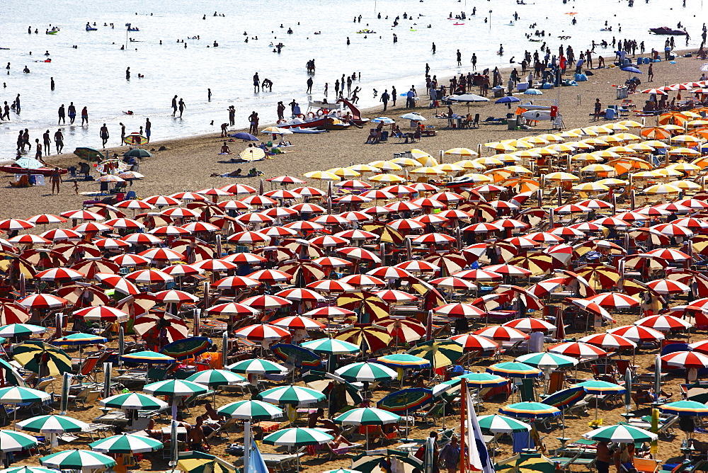 Parasols and sun loungers, mass tourism on the beach of Caorle, Adriatic Sea, Italy, Europe