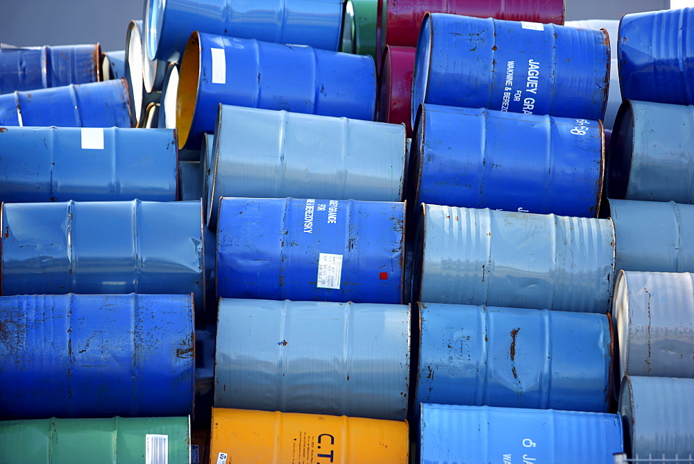 Empty metal drums used for chemicals stockpiled in a recycling company