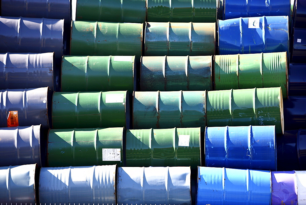 Empty metal drums used for chemicals stockpiled in a recycling company