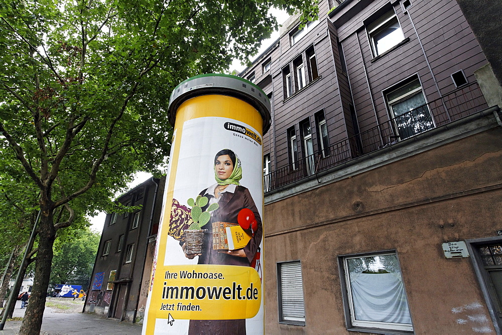 Muslim woman with a headscarf as a promotional figure on a advertising pillar, Bruckhausen district, Duisburg, North Rhine-Westphalia, Germany, Europe