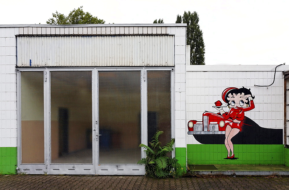 Abandoned car repair shop with a drive-in restaurant, advertising character painted on the wall, Krefeld, North Rhine-Westphalia, Germany, Europe