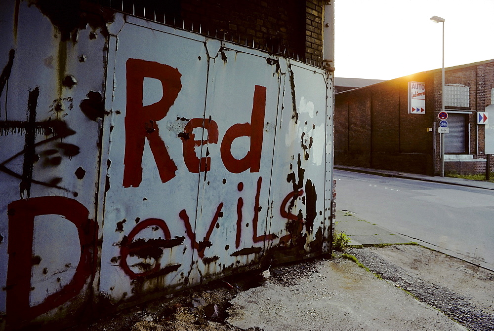 Factory gate painted with graffiti, Red Devils, industrial ruins, former Holtz & Willemsen oil factory, Krefeld-Uerdingen, North Rhine-Westphalia, Germany, Europe