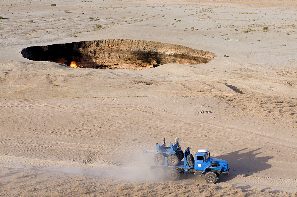 Cross-country vehicle driving on a dusty rural road, Darvaza Gas Crater, Turkmenistan, Central Asia