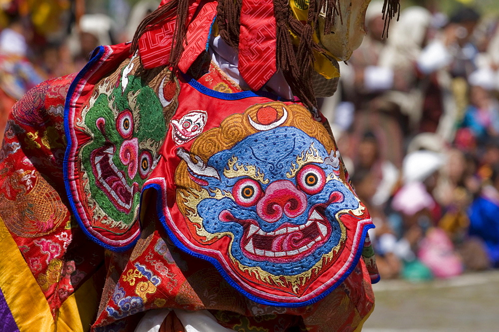 Close up of a traditional dress at religious festivity with male visitors and dances, Paro Tsechu, Bhutan, Asia