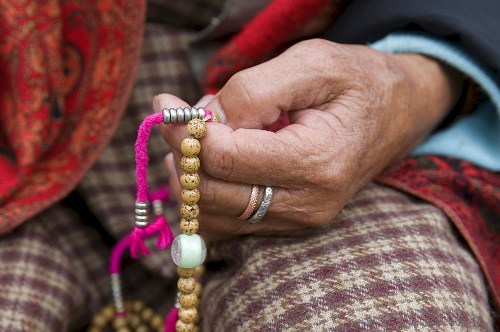 Buddhist pilgrim holding prayer beads, Thimpu, Bhutan, Asia