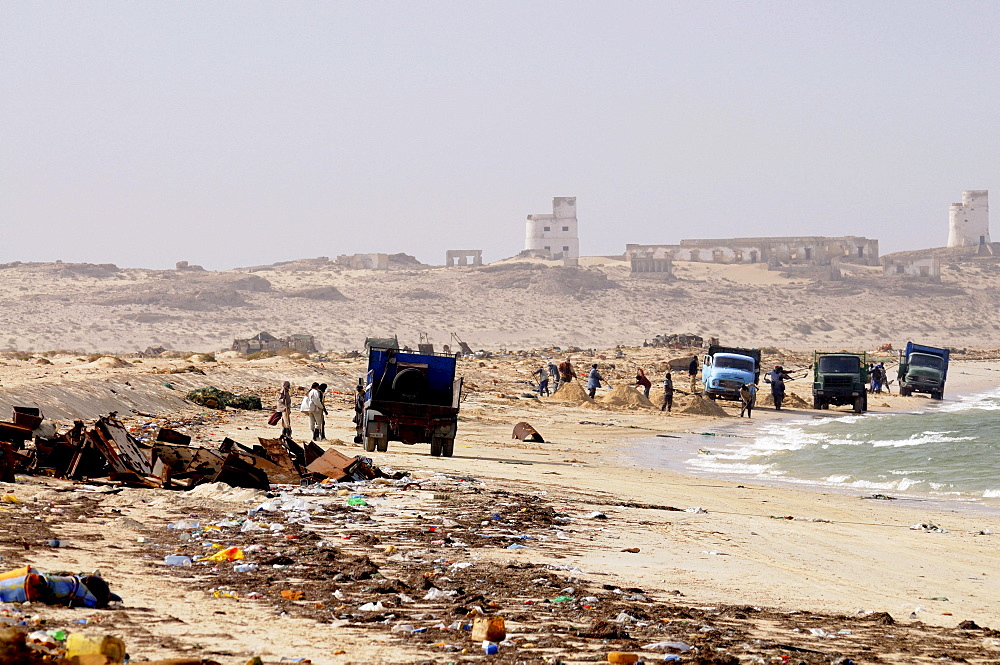 People collecting metal and other parts of rusting ships left over at the ship cemetery of Nouadhibou, Mauritania, Africa