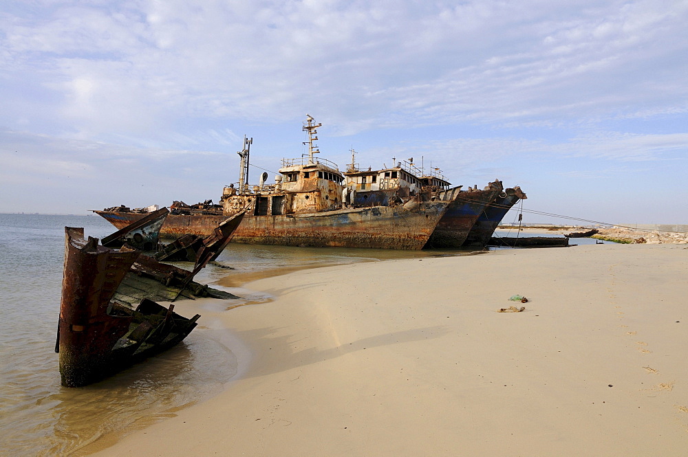 Ship wrecks rusting on the shores of the beach of Nouadhibou, one of the largest ship wreck cemeteries worldwide, Mauritania, northwestern Africa