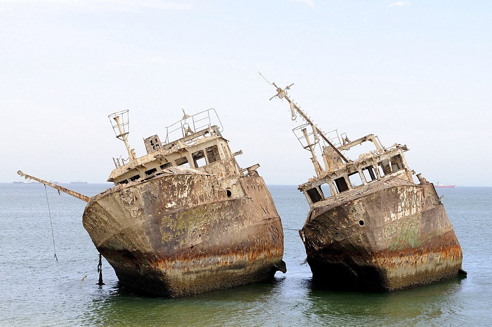 Ship wrecks rusting on the beach of Nouadhibou, one of the largest ship wreck cemeteries worldwide, Mauretania, northwestern Africa